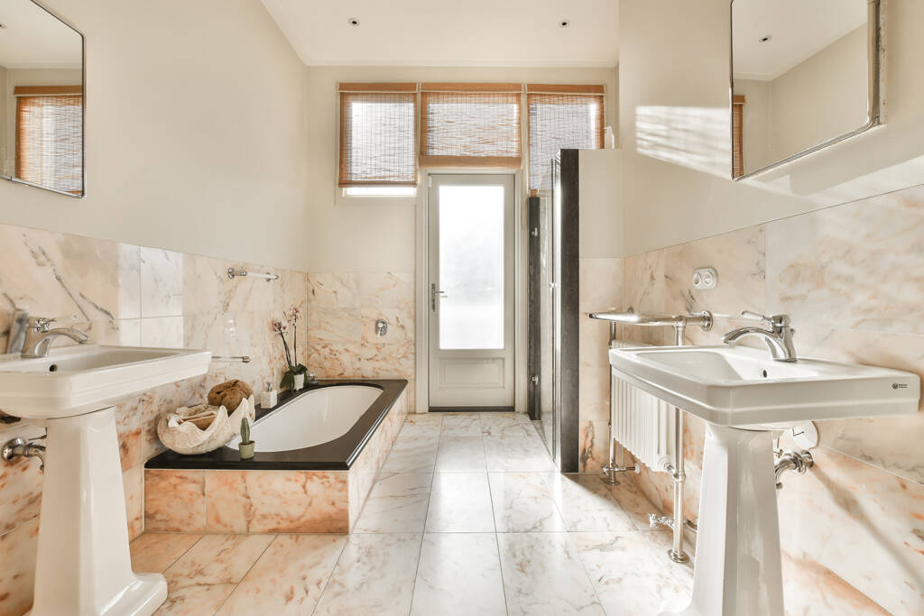 a bathroom with a marble floor and a tub