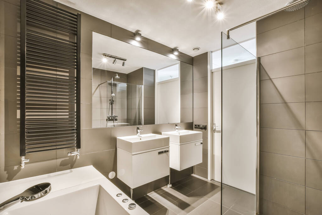 A modern bathroom with two sinks and a shower.