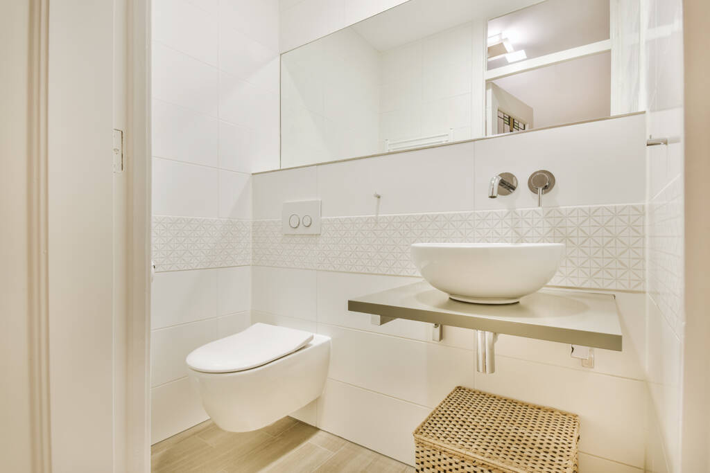 a bathroom with a white sink and a mirror