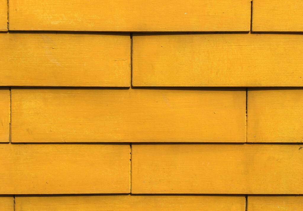 a close up of a yellow siding