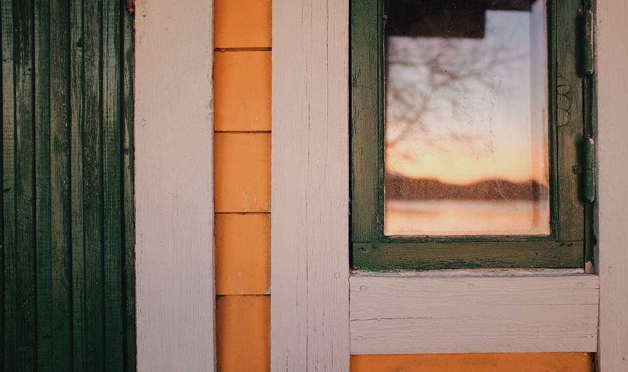 a window with a reflection of a sunset